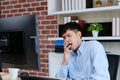 Young asian office man yawning while working on paperwork and computer, Exhausted creative businessman take a break from work at Royalty Free Stock Photo