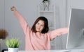 Young asian office woman stretching body for relaxing while working with computer at her desk, office lifestyle, business Royalty Free Stock Photo