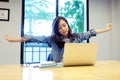 Young asian office woman stretching body for relaxing while working with laptop computer at her desk, office lifestyle, business Royalty Free Stock Photo