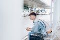 Young asian passenger waiting for taxi at the airport Royalty Free Stock Photo