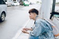 Young asian passenger waiting for taxi at the airport Royalty Free Stock Photo