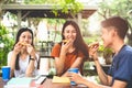 Young Asian people eating pizza together by hands. Food and Friendship celebration party concept. Lifestyles and people in theme.