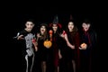 Young Asian people, a group of five persons, in scary costumes. Group of friends having fun at a party in a nightclub to celebrate Royalty Free Stock Photo