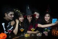 Young Asian people, a group of five persons, in scary costumes selfie their own photo. Group of friends having fun at a party in a