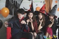 Young Asian people, a group of four persons, in scary costumes selfie their own photo.