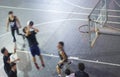 High angle view of young Asian people playing basketball outdoor at night Royalty Free Stock Photo