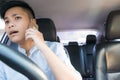 Young Asian people use their phones while driving Royalty Free Stock Photo