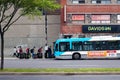 Young Asian people waiting in queue with their lugagges to get on the bus in Montreal, Quebec, canada