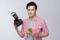 Young asian photographer holding digital camera and color checker card and color palette, while working in studio Royalty Free Stock Photo