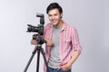 Young asian photographer holding digital camera, while working i Royalty Free Stock Photo