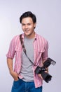 Young asian photographer holding digital camera, while working i Royalty Free Stock Photo