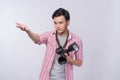 Young asian photographer holding digital camera, while working i Royalty Free Stock Photo