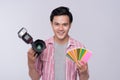 Young asian photographer holding digital camera, while working i Royalty Free Stock Photo