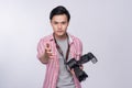 Young asian photographer holding digital camera, while working i Royalty Free Stock Photo