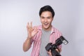 Young asian photographer holding digital camera, while working i Royalty Free Stock Photo