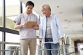 Young asian physical therapist working with old man Royalty Free Stock Photo