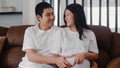 Young Asian Pregnant couple making heart sign holding belly. Mom and Dad feeling happy smiling peaceful while take care baby, Royalty Free Stock Photo