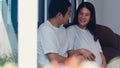 Young Asian Pregnant couple man touch his wife belly talking with his child. Mom and Dad feeling happy smiling peaceful while take Royalty Free Stock Photo