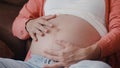 Young Asian Pregnant woman holding her belly talking with her child. Mom feeling happy smiling positive and peaceful while take Royalty Free Stock Photo