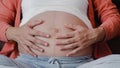 Young Asian Pregnant woman holding her belly talking with her child. Mom feeling happy smiling positive and peaceful while take Royalty Free Stock Photo