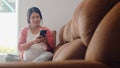 Young Asian Pregnant woman using mobile phone search pregnancy information. Mom feeling happy smiling positive and peaceful while Royalty Free Stock Photo