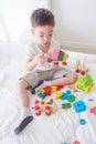 Young boy playing toys on bed Royalty Free Stock Photo