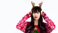 Young asian pretty woman wearing reindeer horns headband snowflake red knitting sweater