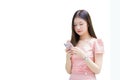 Young Asian professional business woman with long hair is smiling while looking at the smartphone in her hand, work from anywhere Royalty Free Stock Photo