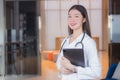 Young Asian professional woman doctor in white lab coat holds tablet in her hand at the clinic in the hospital Royalty Free Stock Photo