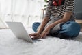 Young asian relaxed smiling pretty woman relaxing with laptop at home. Female feeling joy enjoying with mobile phone on Royalty Free Stock Photo