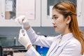 Young Asian researcher looking at the flask in the science labor Royalty Free Stock Photo