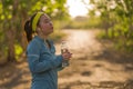 Young Asian runner girl drinking water sweaty and tired. Attractive and exhausted Korean woman thirsty after running workout and Royalty Free Stock Photo