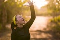 Young Asian runner girl refreshing drinking and pouring water on her head. Attractive and happy Chinese woman tired after running Royalty Free Stock Photo