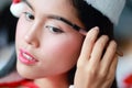 Young asian santa girl applying eye shadow on beautiful face Royalty Free Stock Photo