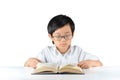 Young Asian schoolboy reading book