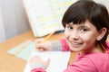 Young Asian schoolgirl doing homework. Royalty Free Stock Photo