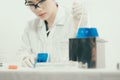 Young Asian scientist working in the lavatory with test tubes and other equipment Royalty Free Stock Photo