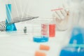 Young Asian scientist working in the lavatory with test tubes and other equipment to discover new drugs Royalty Free Stock Photo