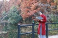 Young asian sensual woman reading a book in romantic autumn scenery.Portrait of pretty young girl in autumnal forest Royalty Free Stock Photo