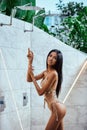 Young asian sexy girl in a beige bikini posing at hotel territory Royalty Free Stock Photo