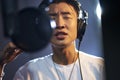 Young asian singer singing in recording studio Royalty Free Stock Photo