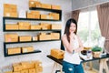 Young Asian small business owner at home office, online marketing packaging and delivery scene