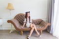 Young asian smile woman sitting on a couch in modern room