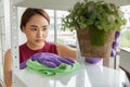 Young Asian smiling woman in gloves cleaning House.