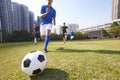 Asian soccer football players chasing the ball Royalty Free Stock Photo