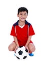 Young asian soccer player with football smiling and holding soccer ball. Studio shot.