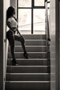 Young asian sportive woman posing in bikini on stairs