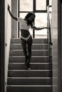 Young asian sportive woman posing in bikini on stairs
