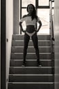 Young asian sportive woman posing in bikini on stairs