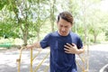 Young Asian sportman Feeling chest pain and Arrhythmia or tachycardia after exercise and running in the garden